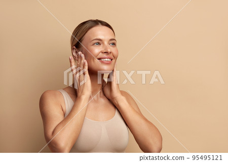 Smiling Woman Touching Chics. Portrait of Attractive Woman Touching her Skin 95495121