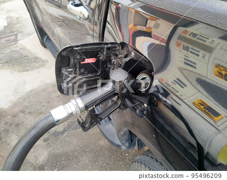 KUALA LUMPUR, MALAYSIA -MARCH 6, 2022: Diesel fuel nozzle used to pumping diesel into vehicle tank at the petrol station. Nozzles should be put in place when not in use. KUALA LUMPUR, MALAYSIA -MARCH 6, 2022: Diesel fuel nozzle used to pumping diesel into vehicle tank at the petrol station. Nozzles should be put in place when not in use. 95496209