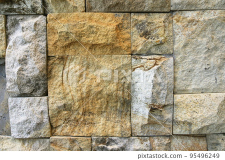 Artificial stone cladding. Designed to resemble real stone. Arranged vertically and attached to the wall with a special adhesive. Used as decoration on the walls of buildings. Artificial stone cladding. Designed to resemble real stone. Arranged vertically and attached to the wall with a special adhesive. Used as decoration on the walls of buildings. 95496249