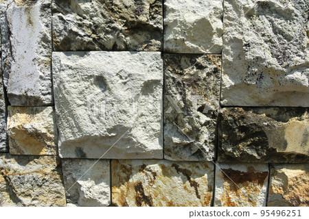 Artificial stone cladding. Designed to resemble real stone. Arranged vertically and attached to the wall with a special adhesive. Used as decoration on the walls of buildings. Artificial stone cladding. Designed to resemble real stone. Arranged vertically and attached to the wall with a special adhesive. Used as decoration on the walls of buildings. 95496251