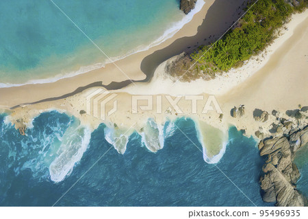Aerial Top Down View of a Sandy Beach Coastline with Splashing Waves 95496935