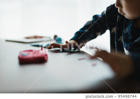 Children playing with clay 95498744