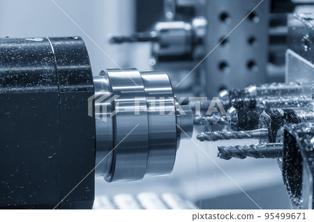 The multi-tasking CNC lathe machine swiss type tapping the brass shaft parts. 95499671