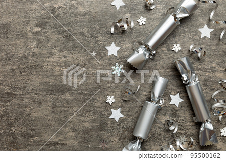 Christmas crackers with shiny confetti on color background, top view, copy space Christmas crackers with shiny confetti on color background, top view, copy space 95500162