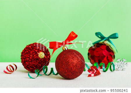 Christmas ball on colored background. decoration bauble with ribbon bow with copy space Christmas ball on colored background. decoration bauble with ribbon bow with copy space 95500241