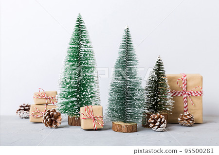 Christmas composition. Gifts, small tree, branches and craft DIY decorations on white background. New year concept. Christmas home decoration Flat lay, top view, copy space Christmas composition. Gifts, small tree, branches and craft DIY decorations on white background. New year concept. Christmas home decoration Flat lay, top view, copy space 95500281