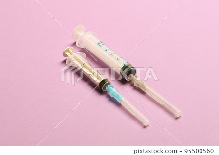 Top view of medical syringes on colorful background with copy space. Injection equipment concept 95500560