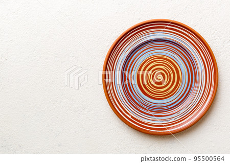 Top view of empty colorful plate on cement background. Empty space for your design 95500564