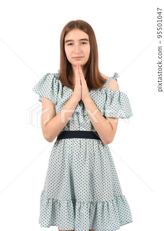 Young beautiful girl in a blue dress with polka dots on a white background 95501047
