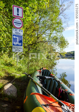 Kayaks on the river bank. Danger. HPP n4 100m. Transfer 200m. 95503175