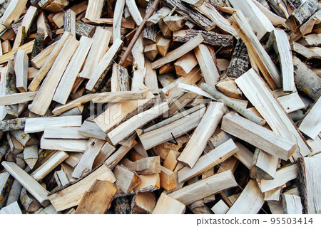 Chaotically arranged in a pile of fresh chopped firewood. Preparation of firewood for the winter. Global or Europe's energy crisis concept. Logging in the village. Rustic lifestyle. Stacks of firewood Chaotically arranged in a pile of fresh chopped firewood. Preparation of firewood for the winter. Global or Europe's energy crisis concept. Logging in the village. Rustic lifestyle. Stacks of firewood 95503414