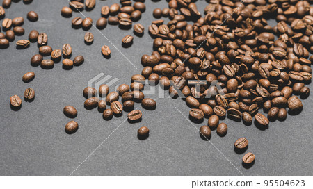 Evenly scattered coffee beans on a black background. Evenly scattered coffee beans on a black background. 95504623