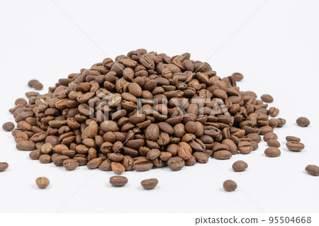 A pile of coffee beans on a white background, place for advertising. A pile of coffee beans on a white background, place for advertising. 95504668
