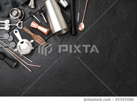 Steel cocktail shaker,strainer,jigger and wooden juicer with muddler on black rubber bar tray. Steel cocktail shaker,strainer,jigger and wooden juicer with muddler on black rubber bar tray. 95505086