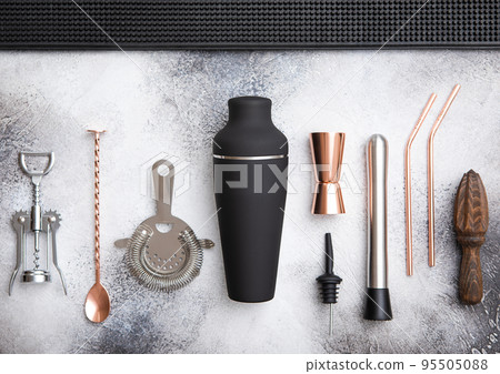 Various cocktail utensils.Copper jigger,straw and spoon with black shaker,muddler and straine Various cocktail utensils.Copper jigger,straw and spoon with black shaker,muddler and straine 95505088