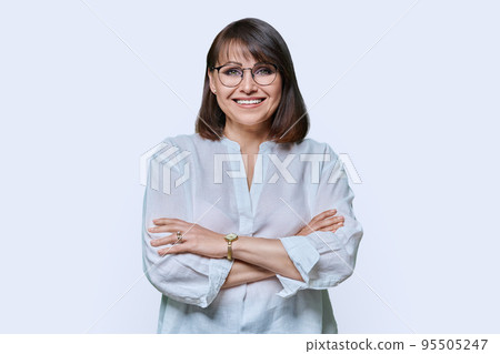 Attractive middle aged woman looking at camera on white background Attractive middle aged woman looking at camera on white background 95505247
