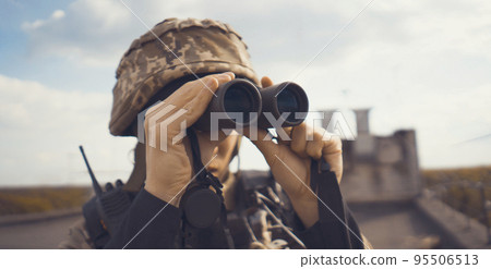 A Man with a binocular and in the military uniform. 95506513