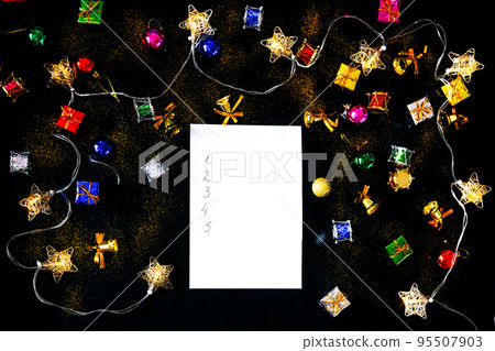Blank sheet of paper and Christmas decorations. List of goals. Blank sheet of paper and Christmas decorations. List of goals. 95507903