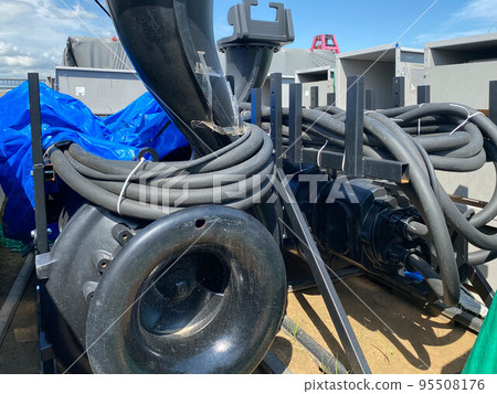 A large pump with an impeller and an impeller stands in a storage warehouse prepared for installation of industrial metal equipment for an oil refinery and petrochemical plant 95508176