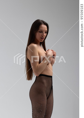 Sexy woman in tights and high heeled shoes in studio 95509183