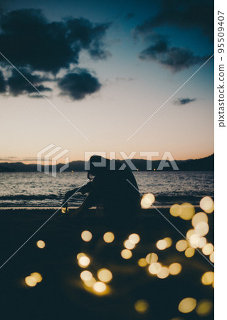 Silhouette photo of a woman standing on the beach Silhouette photo of a woman standing on the beach 95509407