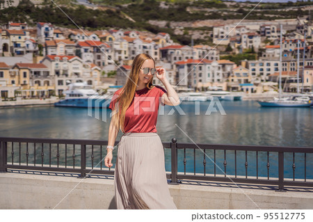 Woman tourist enjoying the views of Architecture and luxury yachts in Lustica Bay, Montenegro. Travel around Montenegro concept. Go Everywhere 95512775