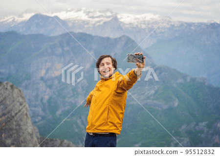 Man tourist on background of Breathtaking panoramic view of the Grlo Sokolovo gorge in Montenegro. In the foreground is a mountain, the flat side of which forms a cliff, and the ridge is overgrown 95512832