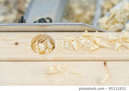 Crpenter builder working overall equals a wooden bar with a milling machine in the workshop 95512852