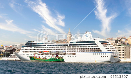 Huge cruise ship docked at Galataport, Bosphorus, Karakoy, district, with Galata Tower, Istanbul, Turkey 95513807