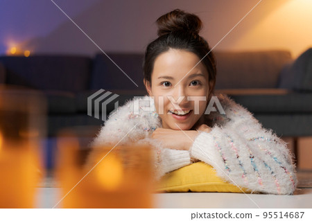 A woman relaxing at home at night 95514687