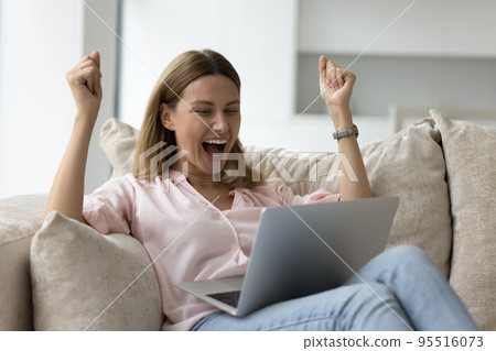 Woman read news on laptop, celebrate success, feels excited Woman read news on laptop, celebrate success, feels excited 95516073