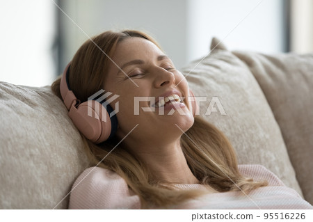 Calm woman listens classic music enjoy leisure and favourite track Calm woman listens classic music enjoy leisure and favourite track 95516226