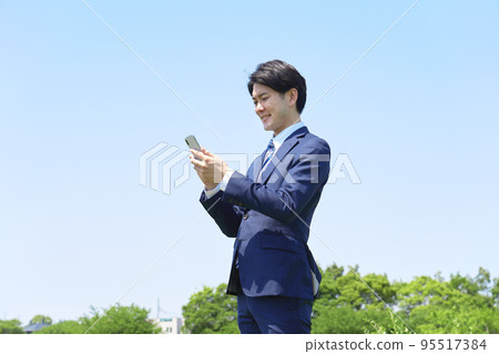 businessman using smartphone outside businessman using smartphone outside 95517384