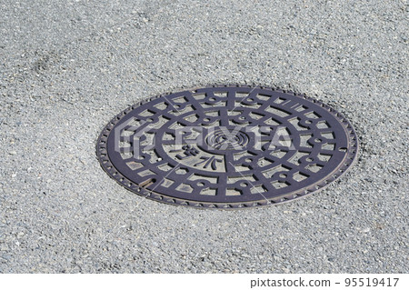 manhole on a sunny day 95519417