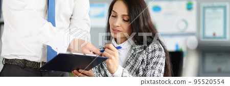Man giving contract paper to businesswoman to sign, worker give agreement paper to boss Man giving contract paper to businesswoman to sign, worker give agreement paper to boss 95520554