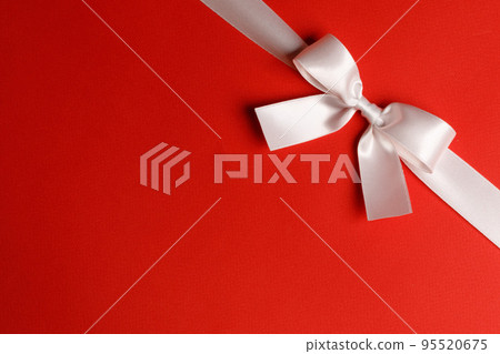 White ribbon bow on red 95520675