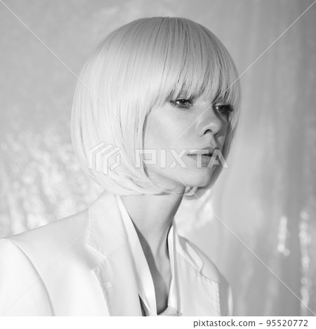 Studio fashion photo of young elegant woman in white men's jacke Studio fashion photo of young elegant woman in white men's jacke 95520772