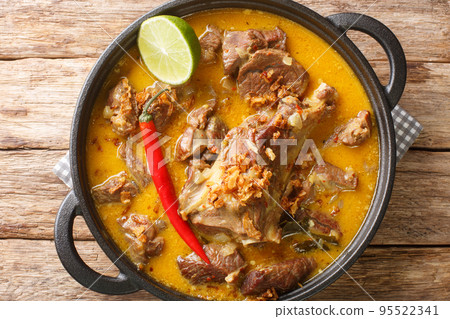 Gulai Kambing or Indonesian Traditional Delicious Goat Curry closeup on the pan. Horizontal top view 95522341