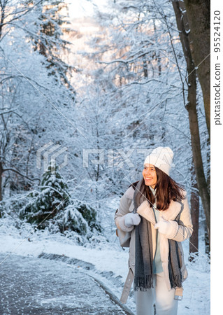 smiling woman walking by winter park smiling woman walking by winter park 95524120