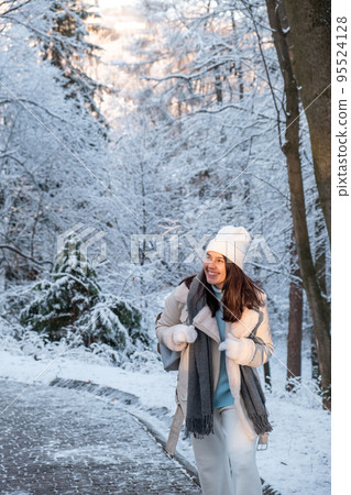 smiling woman walking by winter park smiling woman walking by winter park 95524128
