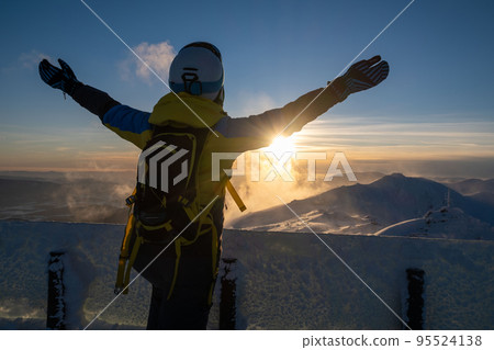 woman skier looking at sunset above slovakia mountains 95524138