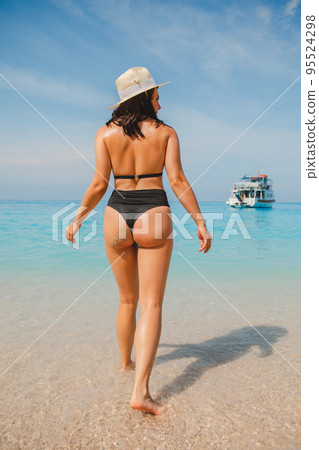 sexy woman in the blue sea water view from behind sexy woman in the blue sea water view from behind 95524298
