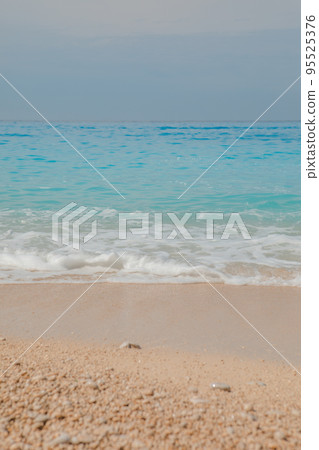 sea beach with white rocks and blue water 95525376