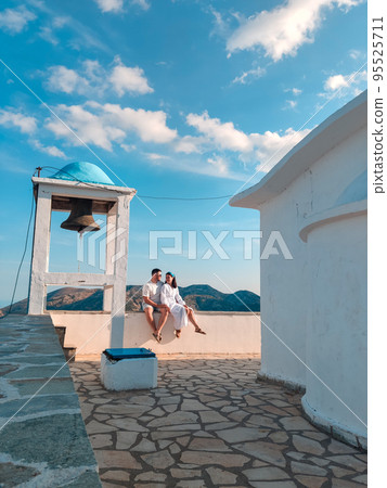 couple travelers near old greece church 95525711
