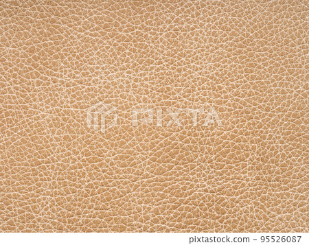 Beige leather texture. Background with copy space, top view. Genuine leather sample closeup in light beige tone. Backdrop textured effect for design, upholstered furniture, clothing. Faux eco leather. 95526087