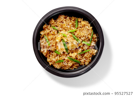 Spicy chahan fried rice dish with chicken, sesame and green onion in black bowl 95527527