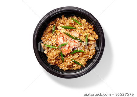 Spicy chahan fried rice dish with shrimps, sesame and green onion in black bowl on white Spicy chahan fried rice dish with shrimps, sesame and green onion in black bowl on white 95527579
