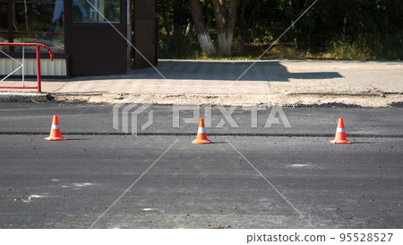 Placement of protective signal cones on the roadway for road repairs 95528527