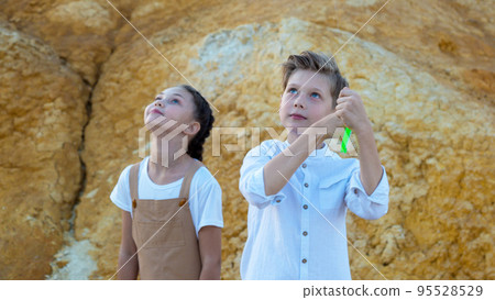 Surprised faces of children watching kite flying in the sky 95528529