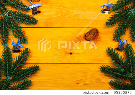 Christmas background. Fir and bells on the wooden table. New Year background. Christmas images, backgrounds. Xmas pine fir lush tree. Bright Winter holiday composition. Greeting card, banner, poster Christmas background. Fir and bells on the wooden table. New Year background. Christmas images, backgrounds. Xmas pine fir lush tree. Bright Winter holiday composition. Greeting card, banner, poster 95530873